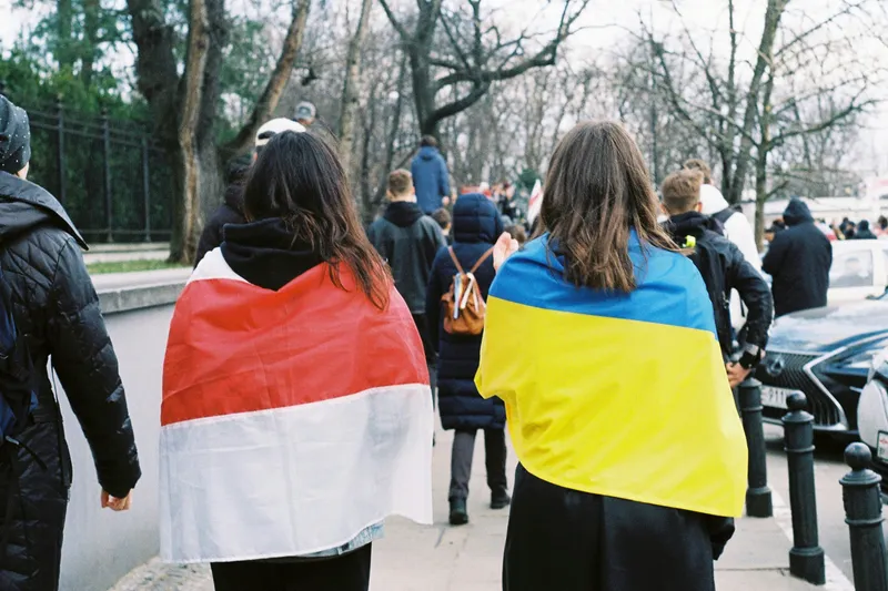 Дівчата, огорнуті в польський та український прапори